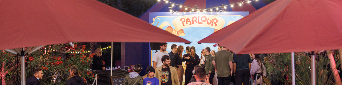 Crowd at event with a Parlour sign