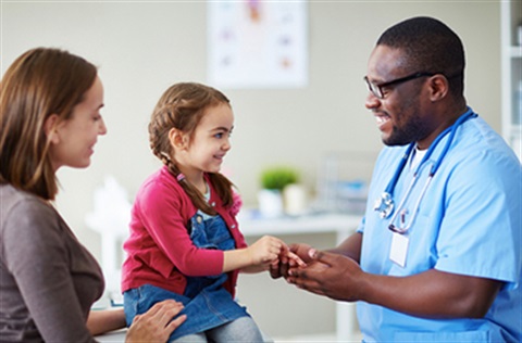 Nurse holding little girl's hand