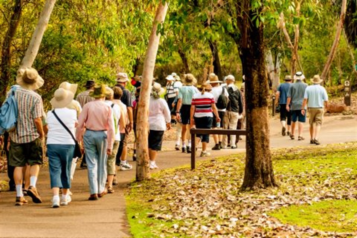 a_group_of_people_walking_along_a_garden_trail.jpg