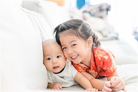 one child and one infant on a couch.jpg