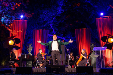 Performer singing on stage at Victoria Gardens