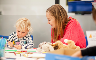 Woman drawing with child